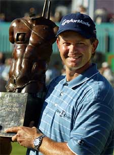 Retief Goosen of South Africa displays his trophy after winning the Lancome Golf tournament 