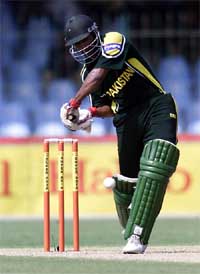 Pakistani batsman Yousuf Youhana drives a ball to reach his half century against Bangladesh in Lahore 
