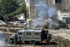 Israeli soldiers detonate explosives at the house of Islamic militant Ahmed Abu Dosh in West Bank