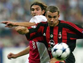 A. C. Milan's Andriy Shevchenko fights for the ball with Julien Escude' of Ajax
