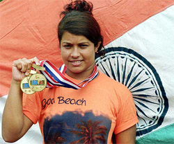 Mamani Mondal, double gold medallist at the Macaw Asian Diving age group championship, display her medals in Kolkata