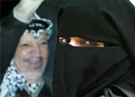 A veiled Palestinian woman attends a rally supporting Palestinian President Yasser Arafat in Gaza City on Wednesday