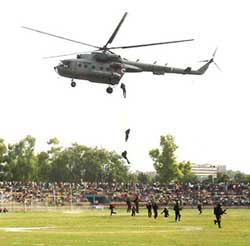 Special forces personnel descend from an air-borne helicopter during an air show in Jammu 