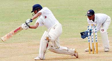 Sachin Tendulkar drives Anil Kumble for four as wicket-keeper Parthiv Patel looks on