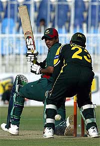 Bangladeshi batsman Rajin Saleh sweeps Pakistani spinner Shoaib Malik in Rawalpindi 