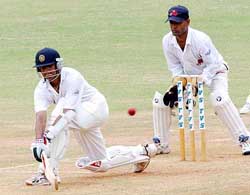 Rest of India's Rahul Dravid sweeps Mumbai spinner Sairaj Bahatule 