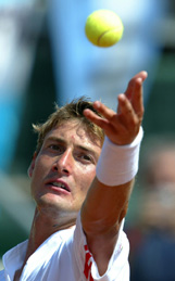 Spain�s Juan Carlos Ferrero serves to Argentina�s Gaston Gaudio 