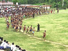 Youths take part in a fitness test during a recruitment rally at the Anoo College ground, Hamirpur