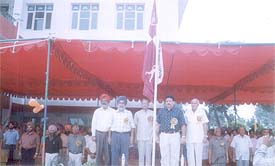 Kartar Singh, Director, Sports, Punjab, hoists the flag at the opening ceremony of a table tennis tournament 