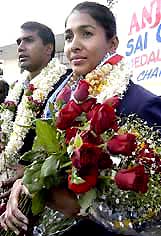 Ace long-jumper Anju Bobby George being welcomed along with her husband and coach Bobby George 