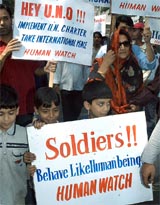 Children and activists carry placards during a march to mark the International Peace Day in Srinagar 
