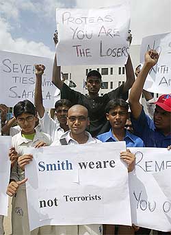 Pakistani cricket fans hold placards during a demonstration outside the National Stadium in Karachi 