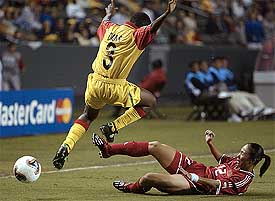 Ghana's Mavis Danso leaps jumps to avoid China's Feifei Qu's tackle at the Women's World Cup 