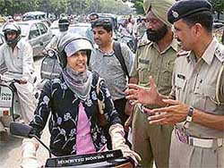One of the recipients of the �award�, Ms Manmeet Kaur, tells the cops why she chose to wear a helmet at the Press Chowk