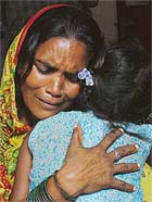 Chanderawati, a resident of the Focal Point area, holds her four-and-half-year-old daughter who was gangraped