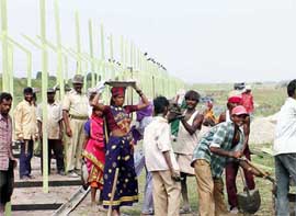 Labourers erect a fence on the LoC in the Kana Chak area of Jammu 
