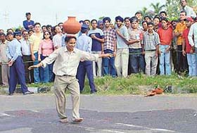 A youngster balances an earthen pot on his head and walks 20m hands free during the shooting of AXN Xtreme Dhamaka