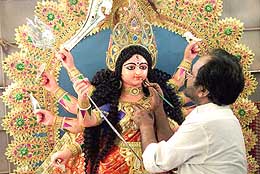 A craftsman puts final touches on an idol of Durga in Bangalore