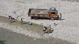 A truck loads bajri and sand from the Poong khad on the Hamirpur-Chauri Road