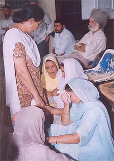 Relatives of dacoity victims wail in a hospital in Ludhiana