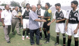 Delhi Soccer Association president Nawabuddin Zaheer and secretary N. K. Bhatia meeting players before the start of the Lt. Governor�s Cup Football Tournament at the Ambedkar Stadium.