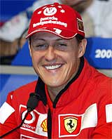 Ferrari driver Michael Schumacher of Germany laughs at a news conference at the Indianapolis Motor Speedway