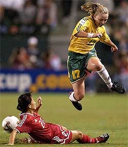 Australia's Danielle Small leaps over Chinese defender Liping Wang during their first round match at the Women�s World Cup