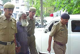 Police personnel taking Jagir Singh to a court in Hamirpur