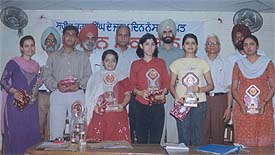 The winners of essay writing competition display they trophies