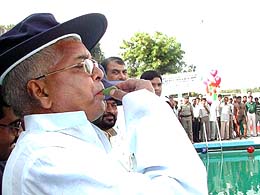 RJD chief Laloo Prasad blows a whistle to inaugurate a swimming pool on the Moinul Haq stadium campus in Patna 