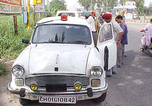A government car belonging to Punjab Transport Department flaunts a flickering red light atop it without displaying the mandatory permission sticker