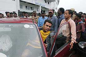 Board President XI captain Virendra Sehwag leaves the ground after the day's play was called off due to rain
