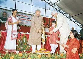 Gujarat Chief Minister Narendra Modi and Nathu Ram Puri light the lamp at the stone-laying ceremony of the Indian Institute of Education and Advanced Research, in Gandhinagar 