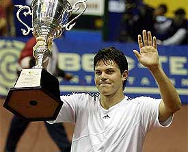 Taylor Dent of the US waves at fans with the Thailand Open trophy after defeating Juan Carlos Ferrero of Spain