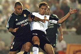 Real Madrid's Ronaldo and Valencia's Curro Torres fight for the ball during their Spanish League match