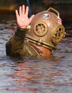 Lloyd Scott, 41, gives a final wave before submerging to begin his underwater marathon world record attempt to raise money for children with Leukemia, in Loch Ness, Scotland