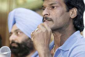Indian hockey captain Dhanraj Pillay addresses the media as coach Rajinder Singh looks on at a Press conference in Chennai