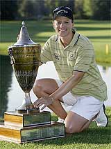 Swedish golfer Annika Sorenstam poses the trophy after winning the Safeway Classic in Portland