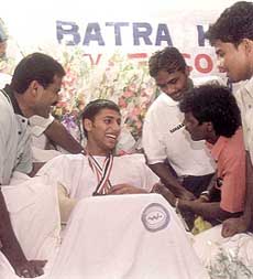 Jugraj Singh is all smiles as he meets the victorious Indian hockey team members who called on him with the Asia Cup at the Batra Hospital in Delhi on Tuesday.