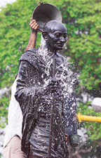A civic worker washes the statue of Mahatma Gandhi on the eve of Gandhi Jayanti in Ahmedabad on Wednesday.