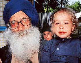 Relatives of the massacred Sikhs sit in front of the memorial at Chattisinghpora village in Anantnag district of Jammu and Kashmir