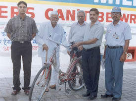 Mr Shashi Pal Joshi, winner of BPCL petro card lucky draw, being presented a bicycle by Mr Anant Ram