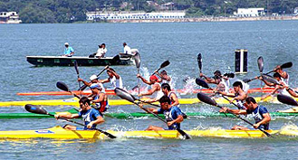 Competitors from different countries in 1000m men's Kayaking-4 semifinal competition at Upper Lake in Bhopal