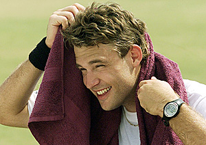 Spin bowler Daniel Vettori of New Zealand covers his face to escape the heat