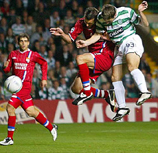 Celtic's Liam Miller puts the ball past Olympique Lyon's Eric Deflandre