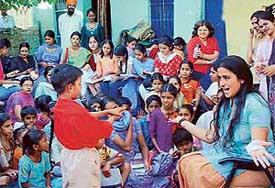 An NSS volunteer of MCM DAV College, Sector 36, teaches a child at Badheri on the fifth day of a camp