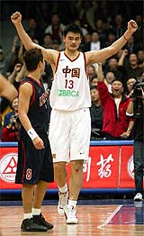 China's NBA star player Yao Ming celebrates as South Korea's Bang Sung-Yoon looks on