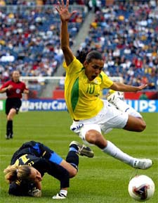 Brazil's forward Marta is taken down by Sweden's goalkeeper Sofia Lundgren