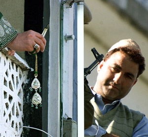 A Kashmiri man looks at a relic