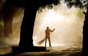 A sweeper cleans a street